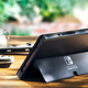 An outdoors shot showing off the Nintendo Switch (OLED Model)'s new ultra-wide kickstand.